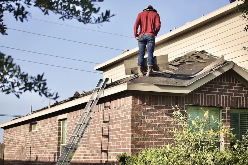 Professional roofer working on a residential roof in Cimarron Hills